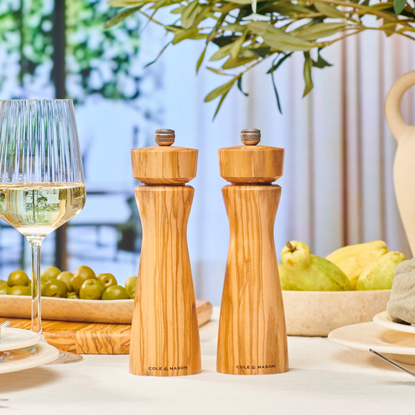 #salt The Cole & Mason Portobello Olive Wood Salt & Pepper Mills, with adjustable grind, add style to any meal. Presented in a premium gift box, they’re perfect on a dining table set with wine, olives, fruit, and tableware.