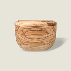 The Portobello Olive Wood Salt Cellar by Cole & Mason features natural grain patterns, a matching lid, and the brand logo on the front, adding timeless charm to your kitchen decor. Shown against a plain light background.