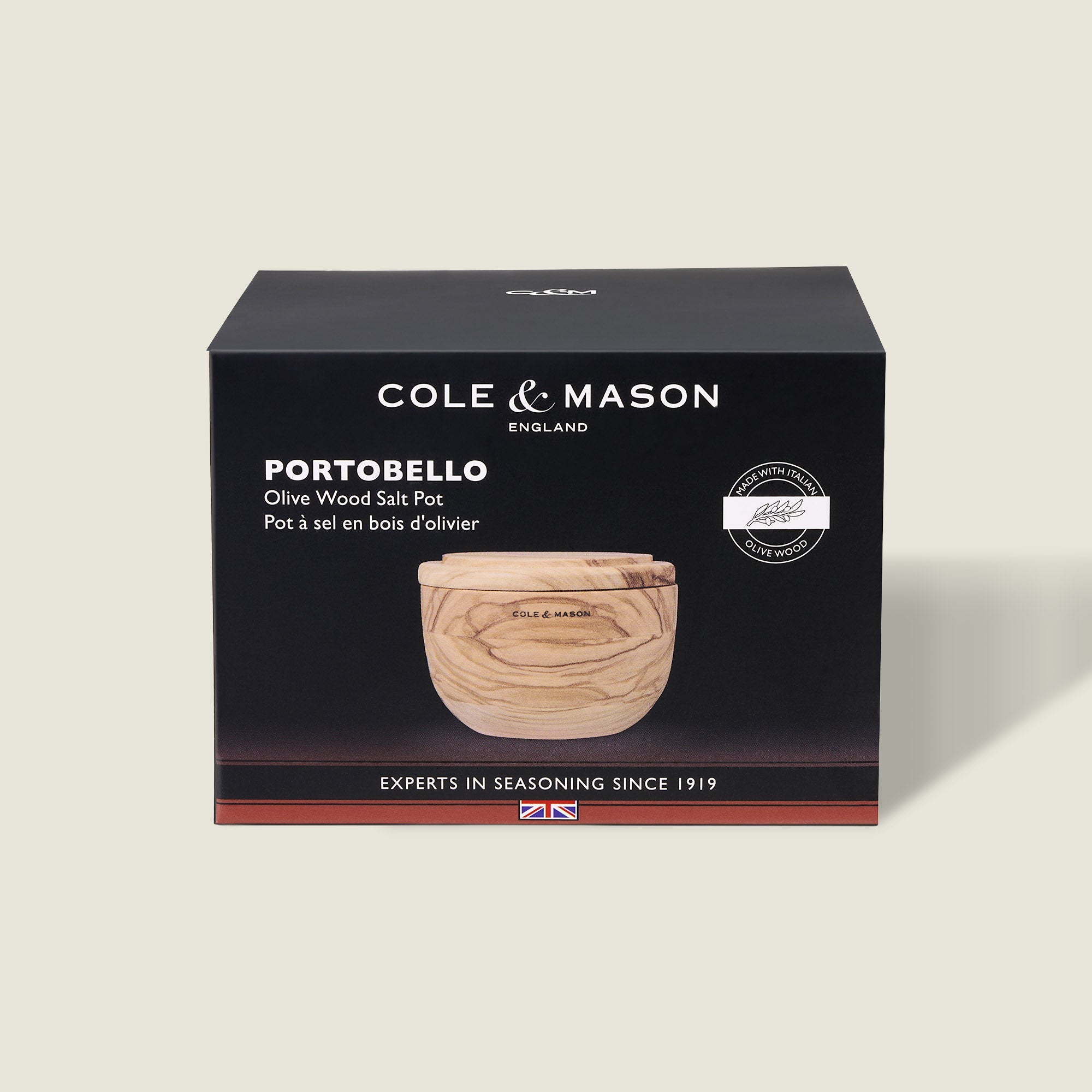 A Cole & Mason box displays the Portobello Olive Wood Salt Cellar—a small, round wooden container with a lid. The mostly black packaging features white text and a product image, making it perfect for stylish kitchen decor.